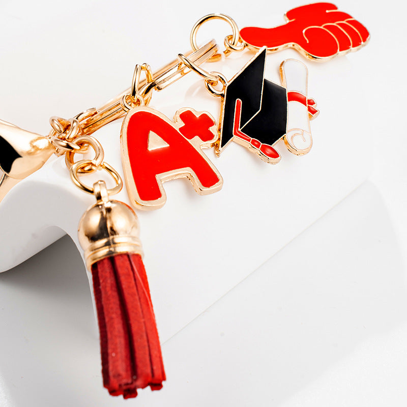 Portachiavi Laurea Cappello Pollice in Su Nappe Rosso